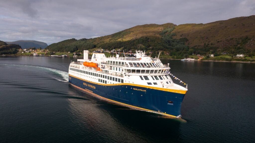 Havila Pollux dressed overall, under way in summer