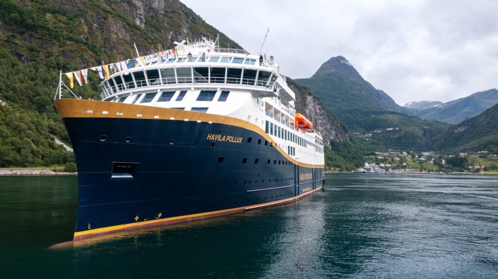 Havila Pollux in a steep-sided fjord
