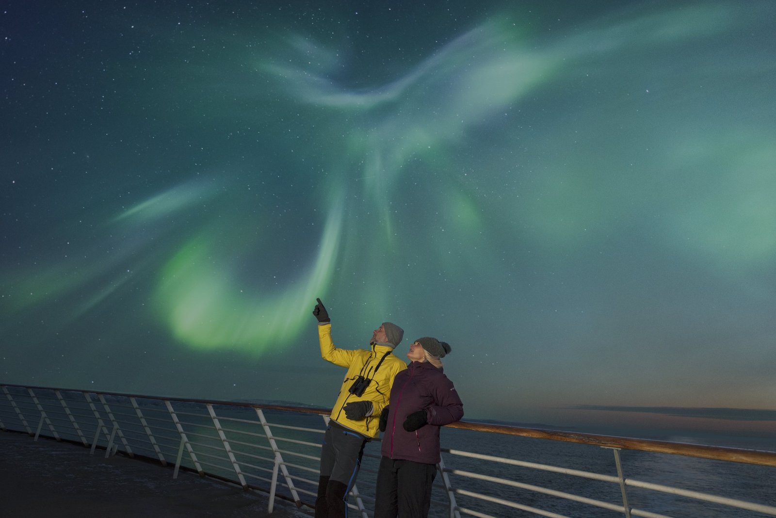 The northern lights seen from the open deck of a Hurtigruten ship on the Norwegian coast