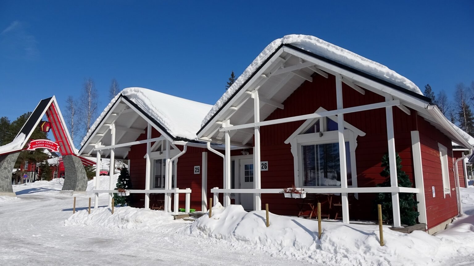 Cottages beside the Santa Claus Holiday Village gateway sign, Rovaniemi