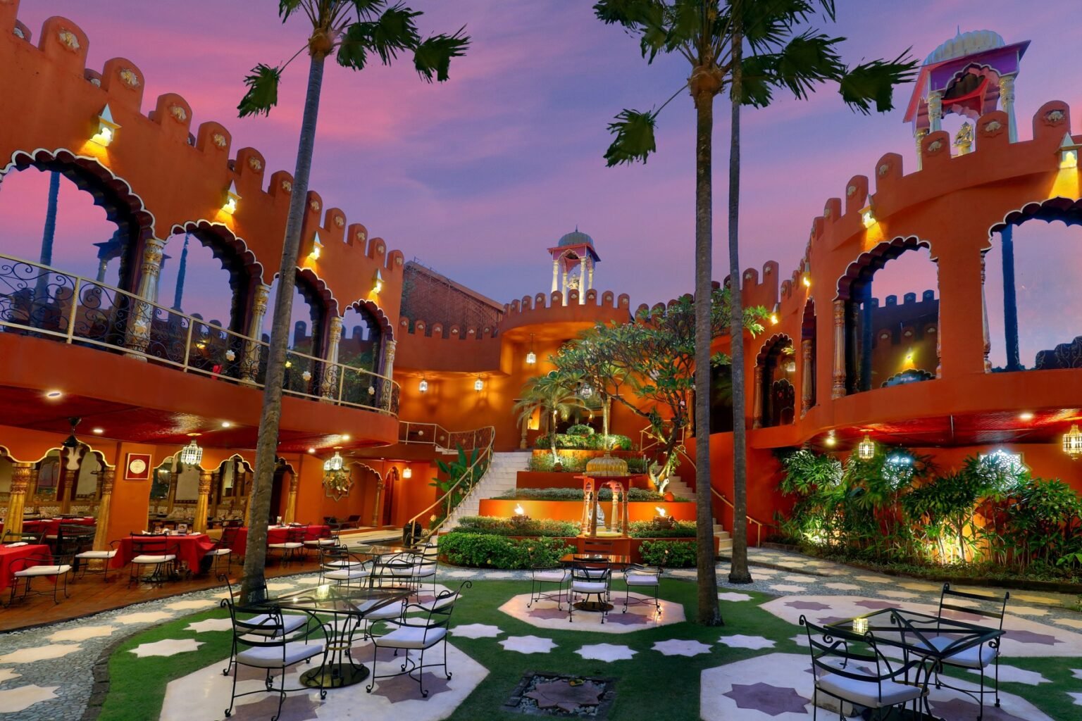 A spa courtyard with patterned tilework, arched openings and planting.