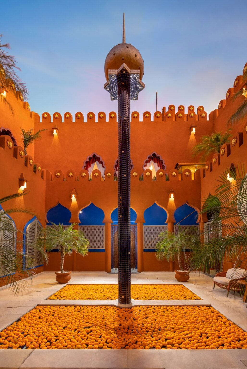 A small tiled plunge pool lit at dusk inside a spa courtyard.
