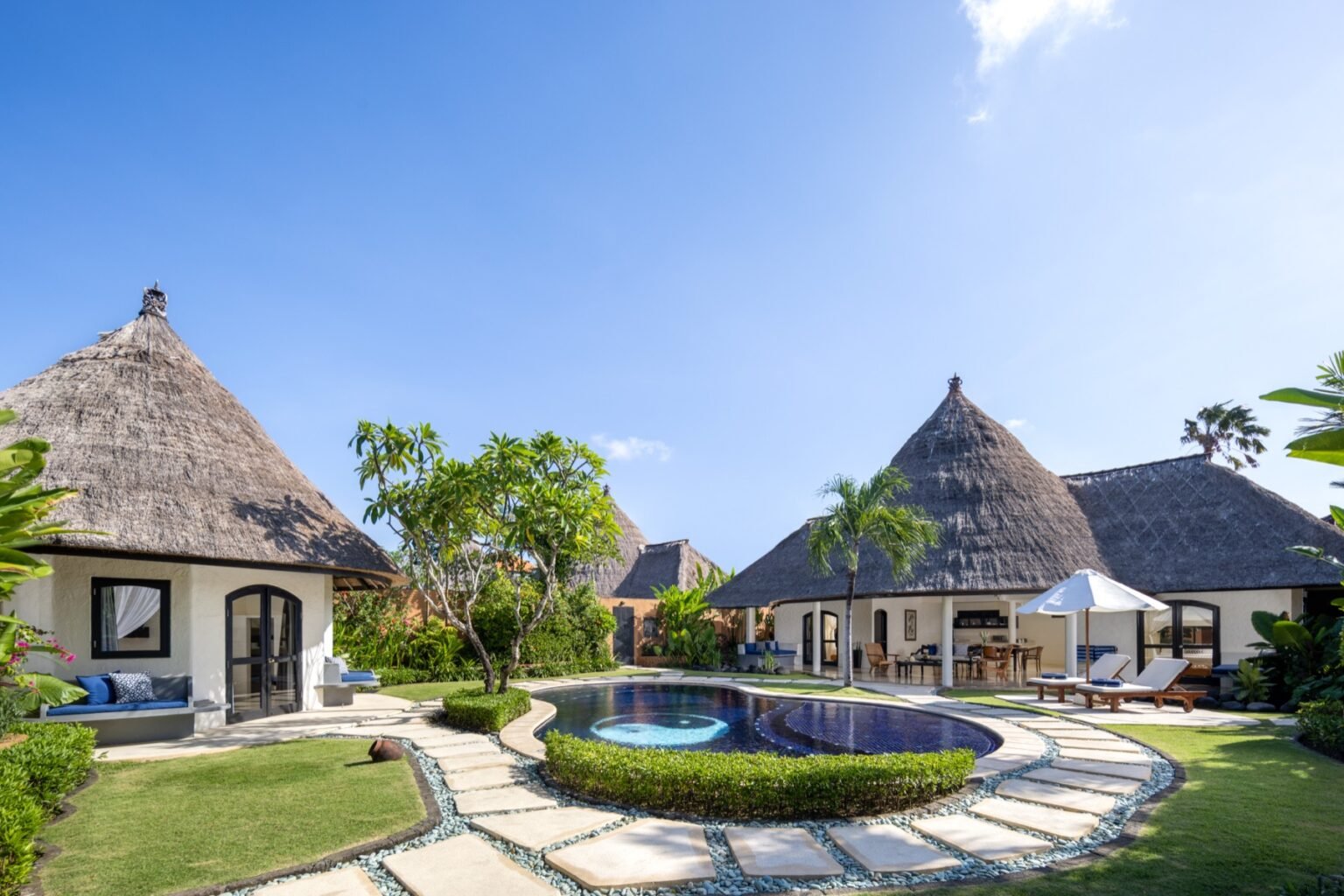 A three-bedroom villa from above, with a large pool and a separate round pavilion across the garden.