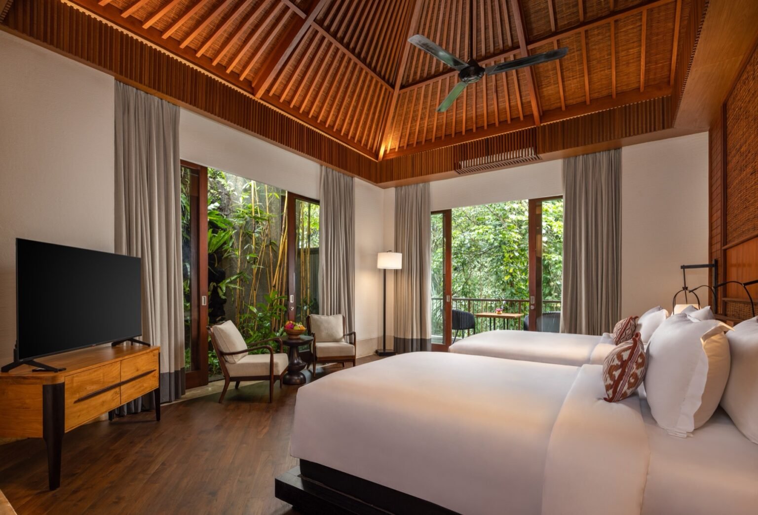 A villa bedroom with two single beds and timber joinery.