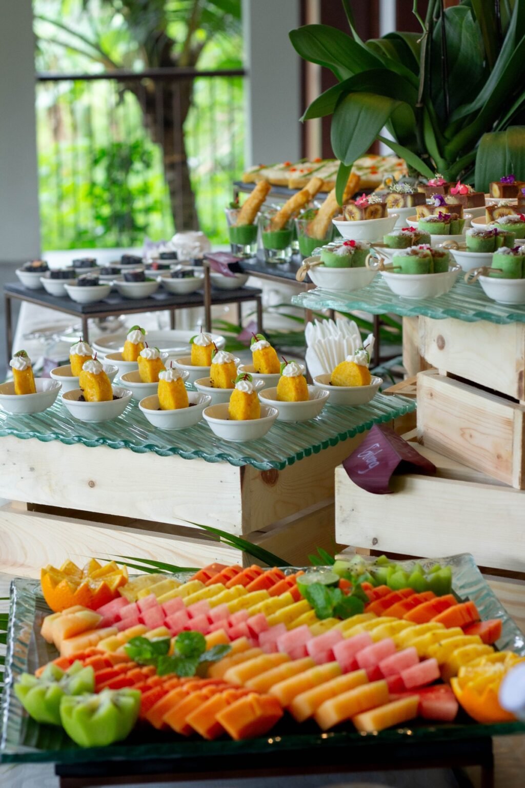 A coffee break station with tiered stands of pastries and desserts.