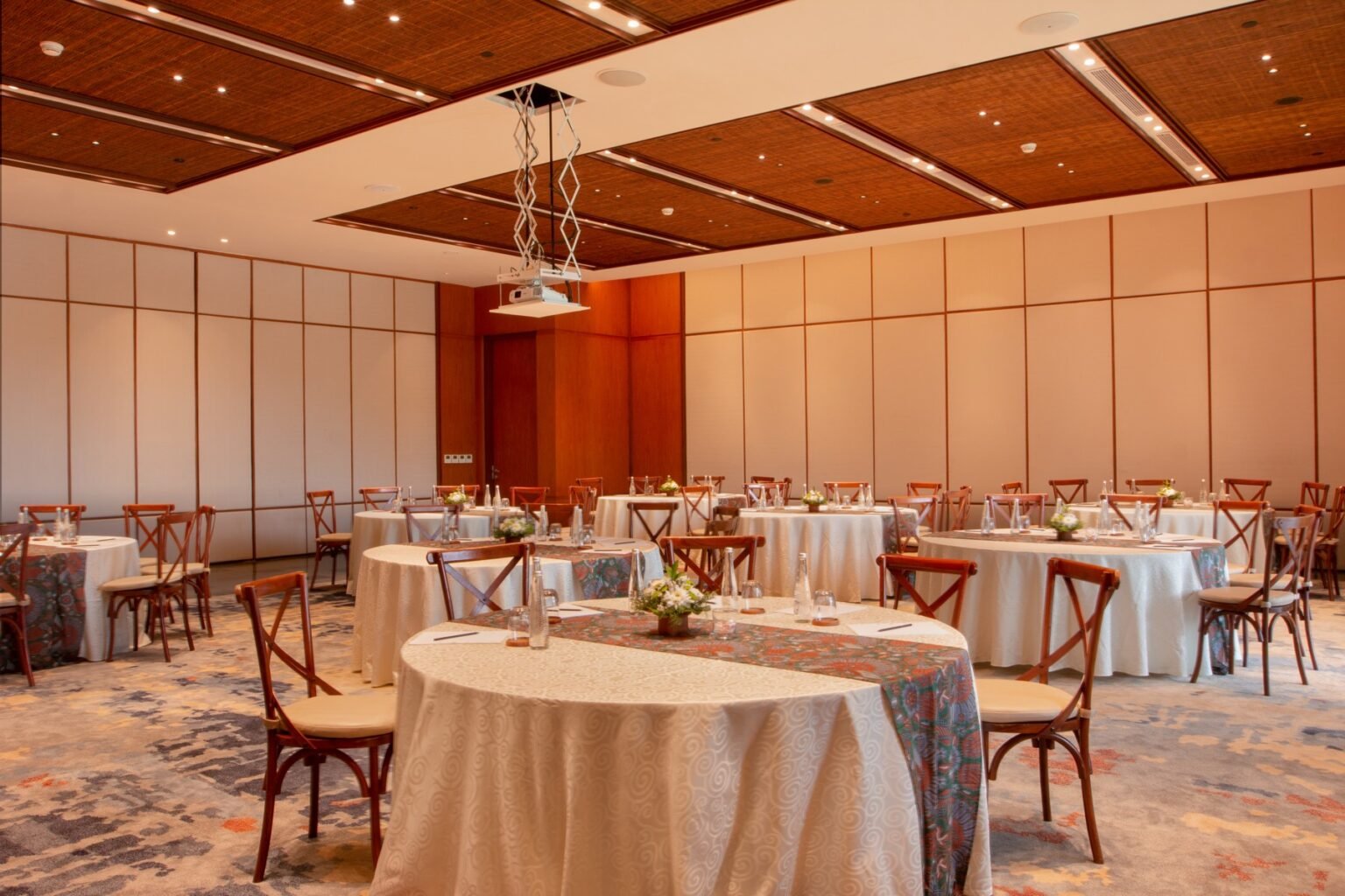 A function room laid out with round tables and chairs.