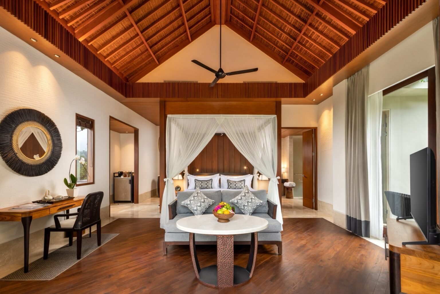 A villa pool on a terrace with loungers under a pergola, jungle beyond.