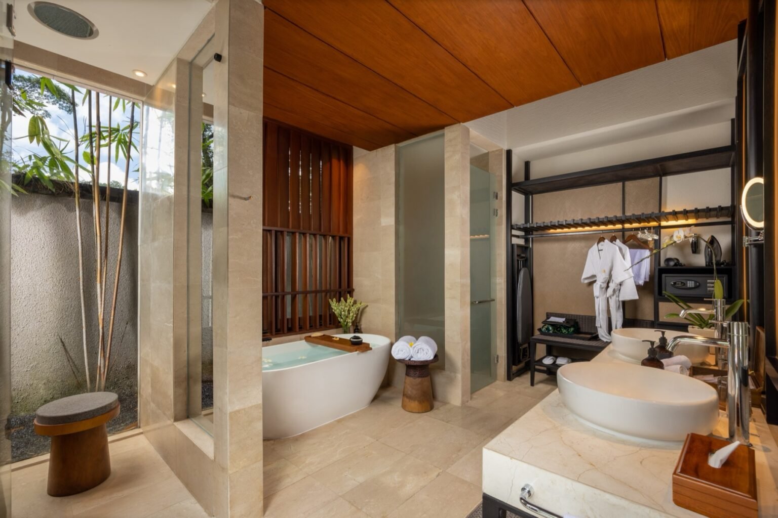 A bathroom with a bath, a basin counter and timber joinery.