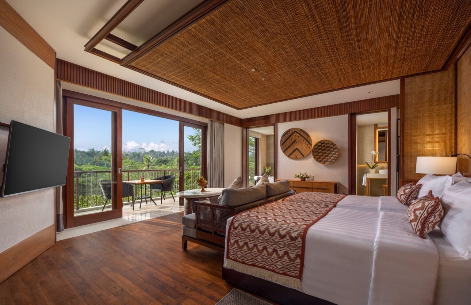 A suite balcony with seating looking into garden planting.