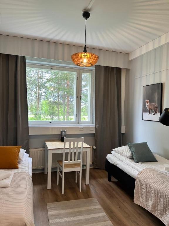 A room at the boutique hotel in Kemijarvi with a table by the window