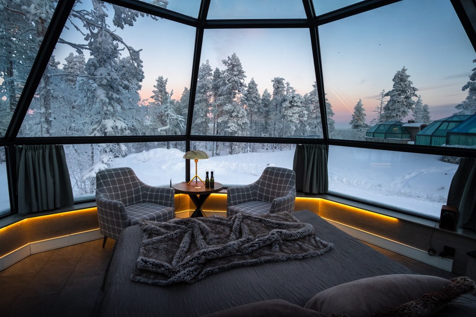 Inside a glass igloo, bed beneath the glass roof — Levin Iglut – Golden Crown, Levi