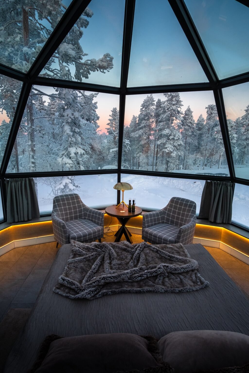 Inside a glass igloo, bed beneath the glass roof — Levin Iglut – Golden Crown, Levi