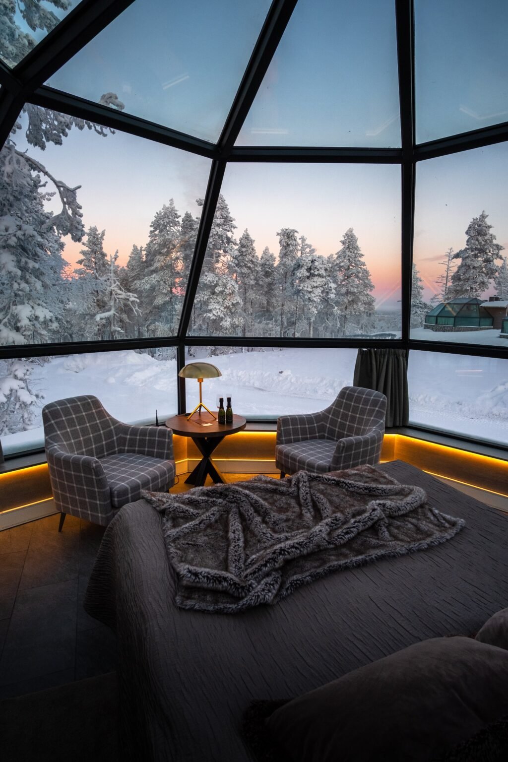 Inside a glass igloo, bed beneath the glass roof — Levin Iglut – Golden Crown, Levi