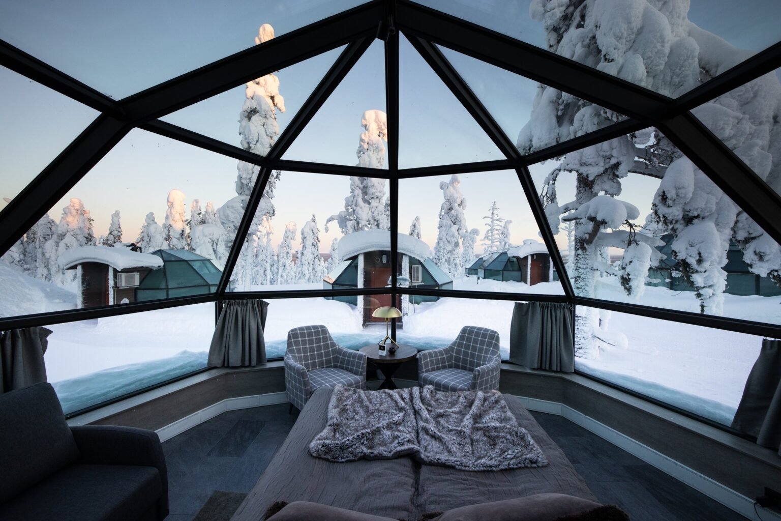 Inside a glass igloo, bed beneath the glass roof — Levin Iglut – Golden Crown, Levi