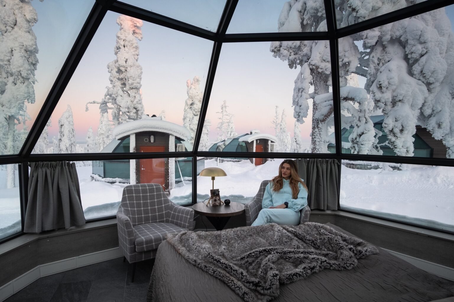 Inside a glass igloo, bed beneath the glass roof — Levin Iglut – Golden Crown, Levi