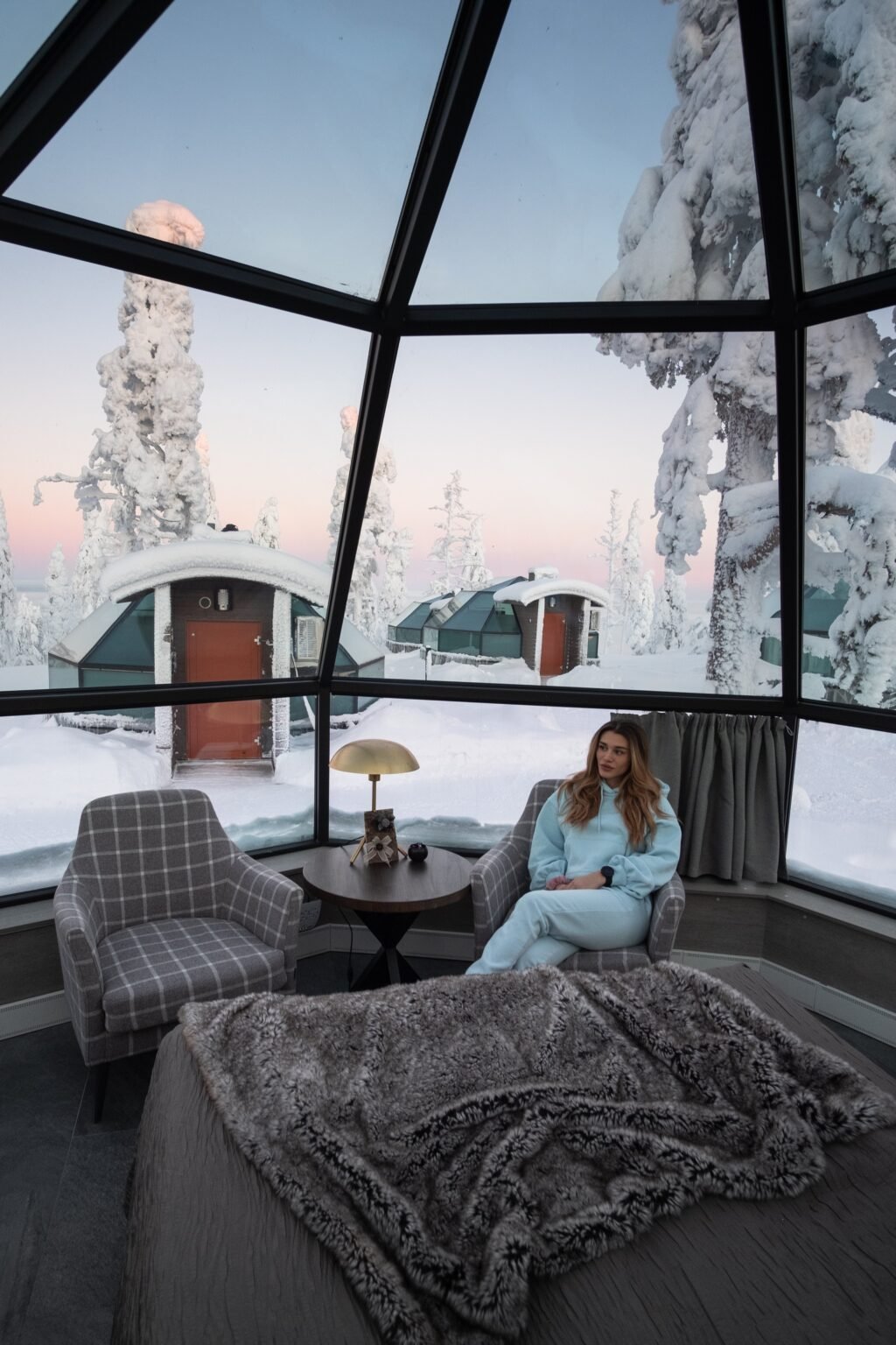 Inside a glass igloo, bed beneath the glass roof — Levin Iglut – Golden Crown, Levi