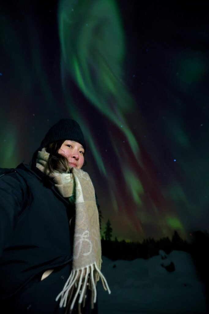 The northern lights over snow-covered forest in Lapland