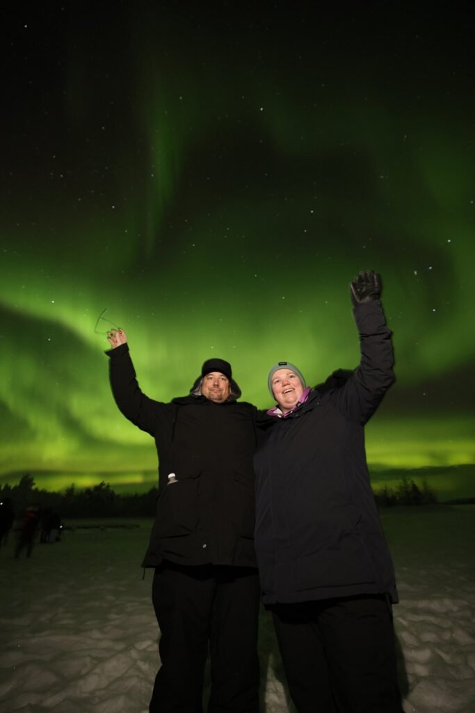 The northern lights over snow-covered forest in Lapland