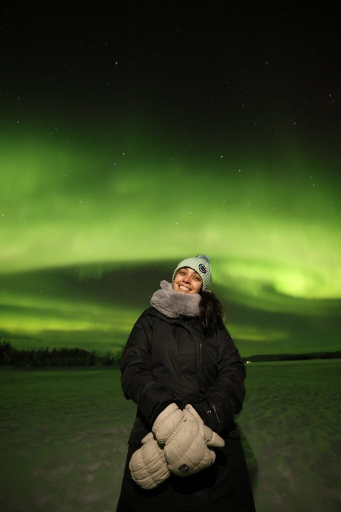 The northern lights over snow-covered forest in Lapland