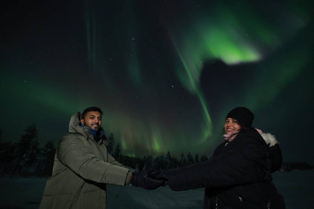 The northern lights over snow-covered forest in Lapland