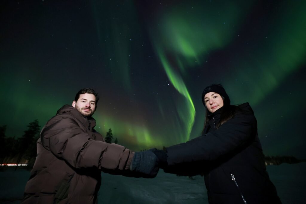 The northern lights over snow-covered forest in Lapland