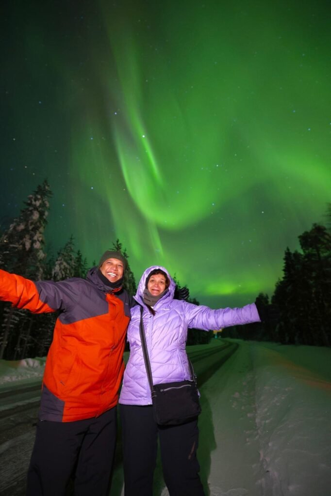 The northern lights over snow-covered forest in Lapland