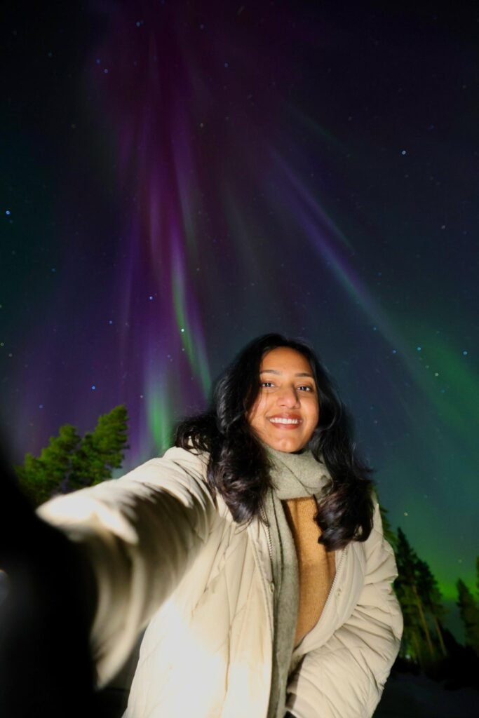 The northern lights over snow-covered forest in Lapland