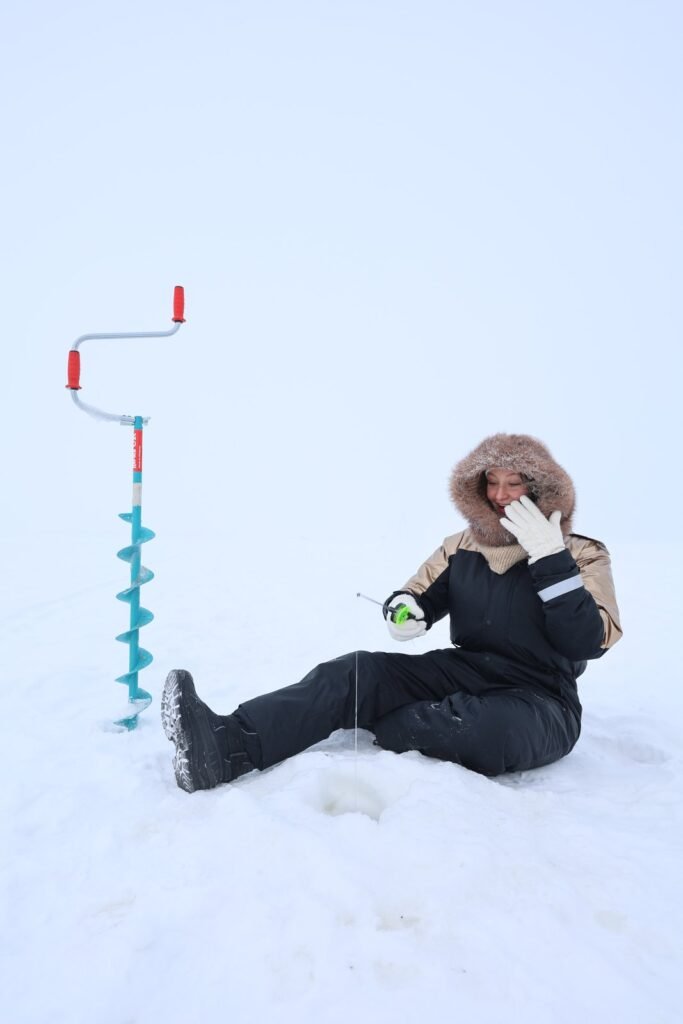 Ice fishing on a frozen lake in Lapland