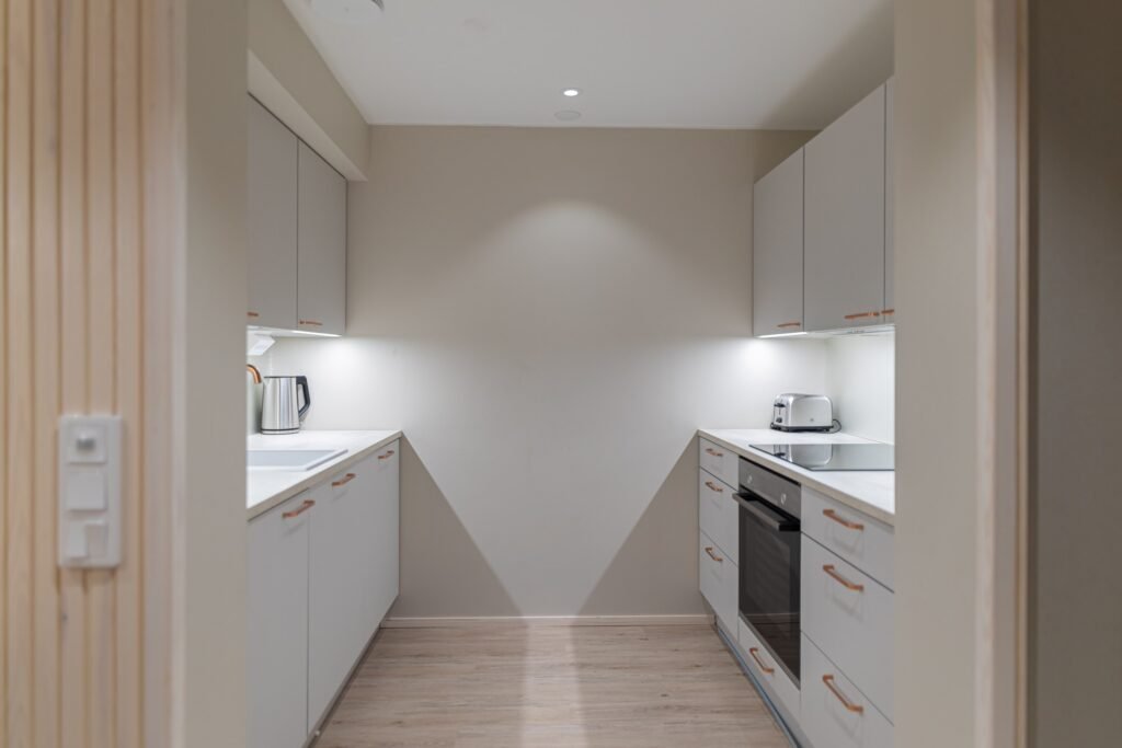 A fully fitted kitchen with an oven, hob and kettle in an apartment in central Rovaniemi