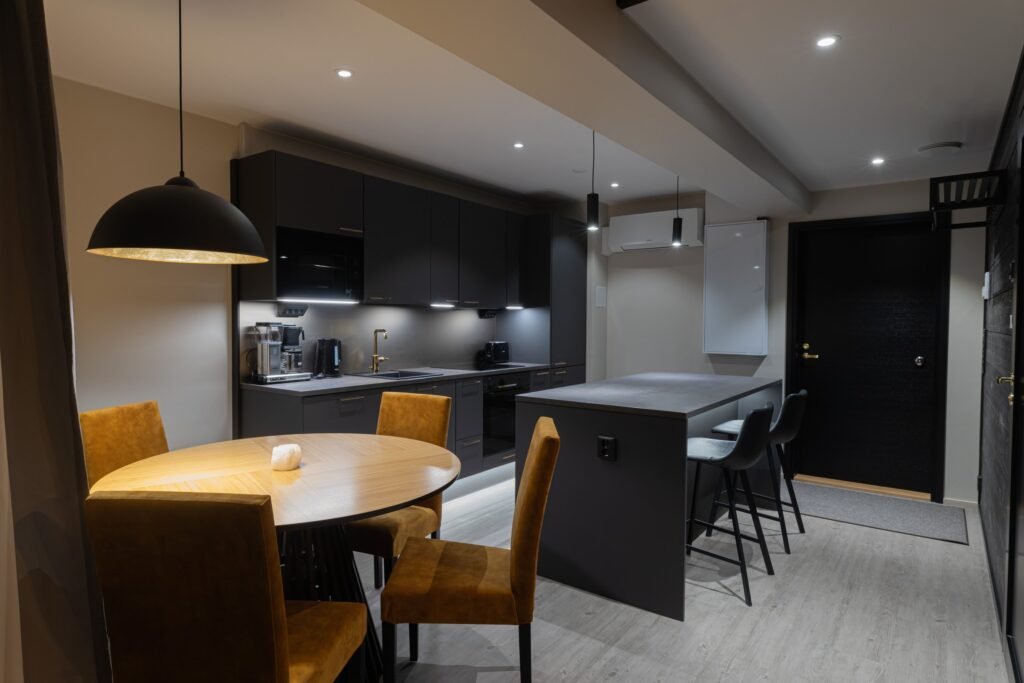 An open kitchen and dining area with a breakfast bar in an apartment in central Rovaniemi