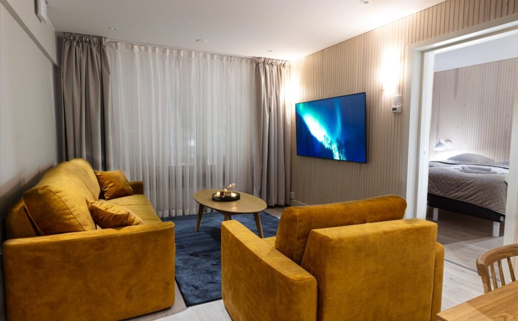 The living area of a two-bedroom apartment in central Rovaniemi, with a doorway through to a bedroom