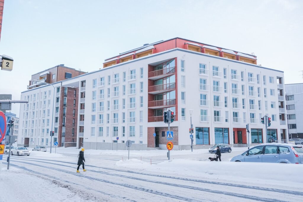 A modern apartment building on a snowy street corner in central Rovaniemi
