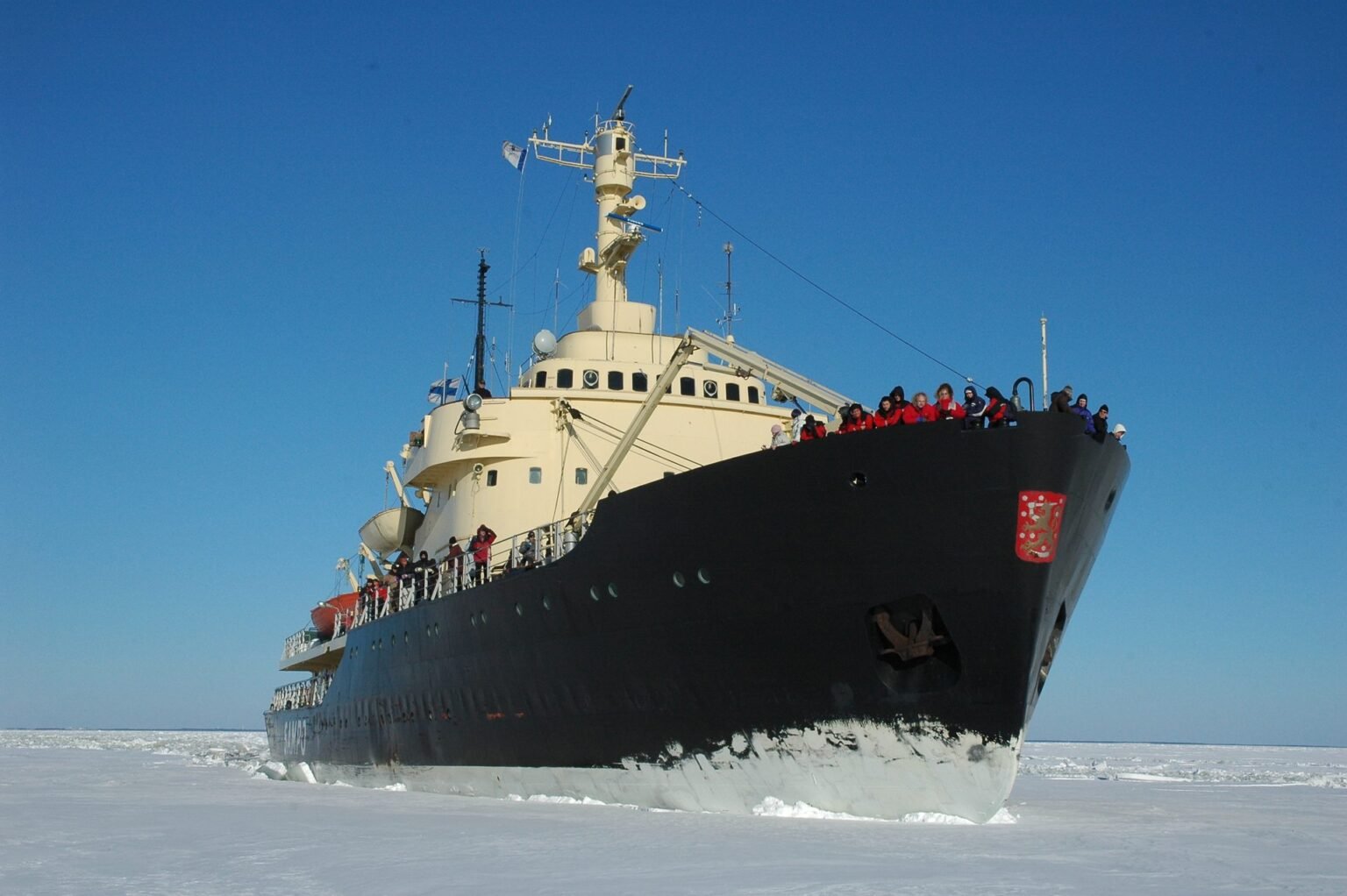 The Sampo in the frozen Gulf of Bothnia, passengers at the bow rail
